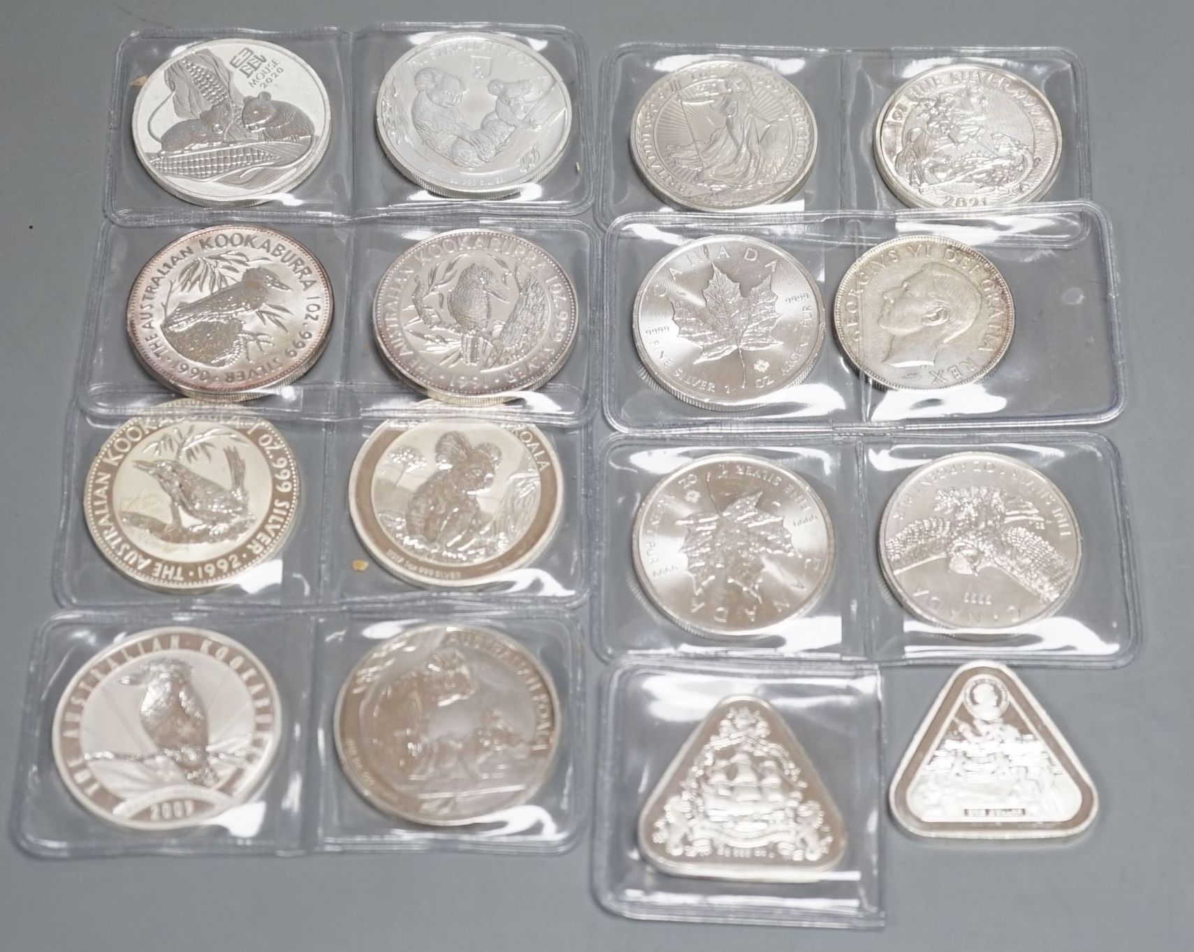 Eight 1oz assorted Australian 1 dollar coins, finesse .999, four 1oz assorted Canadian dollar coins, two silver 1oz coins- Britannia 2019 and George & Dragon, 2021 and two silver Australian triangular 1oz coins, 2019/202